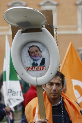 A protester suggests Mr Berlusconi is out of date.