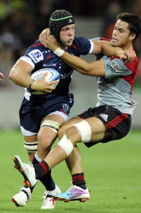 League convert Jarrod Saffy is tackled by Sean Maitland of the Crusaders.
