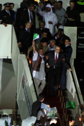 Abdelbaset al-Megrahi (in suit) arrives in Tripoli.