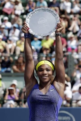 Serena Williams holds the winner's trophy after defeating Angelique Kerber.
