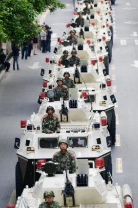 A convoy of armoured vehicles parades through Urumqi in a show of force on Friday, the day after a terrorist attack on a city market that has so far claimed the lives of 43 people.