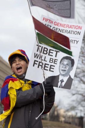 A young Free Tibet supporter waves a flag in protest. A spate of Tibetans have set themselves on fire protesting against the Chinese government.
