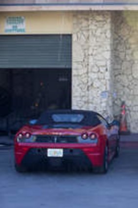 A yellow Lamborghini, right, and a Ferrari, left, allegedly involved in Bieber's drag race are shown in an impound lot in Miami Beach, Florida.