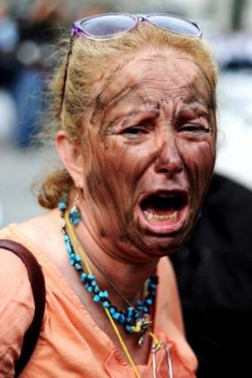 Widespread anger at poor safety record ... A Turkish woman with her face painted as a miners', shouts slogans during a protest in Istanbul, a day after an explosion in a coal mine.