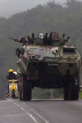 Malaysian soldiers patrol in an armoured personnel carrier near the village of Tanduo.