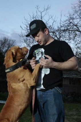Justen Storay from Griffith plays with his dog Laps in his backyard.