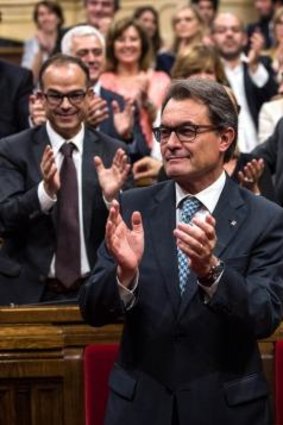 Lesson in democracy: President of Catalonia Artur Mas, front left, celebrates after the Catalan Parliament approves a law for an independence referendum.