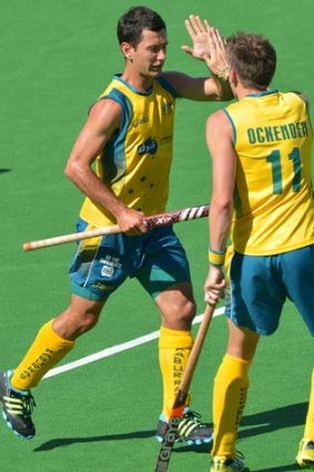 Jamie Dwyer of Australia (L) is congratulated by team mate Eddie Ockenden (R) after scoring against India.