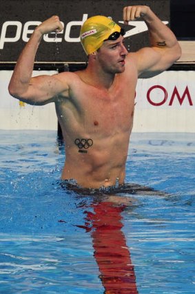 Turning tide: James Magnussen celebrates gold following victory in the 100 metres freestyle on Thursday.