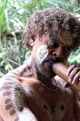 A man demonstrates his didgeridoo skills.