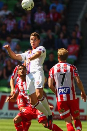 Heads up &#8230; Perth Glory's Shane Smeltz is first to the ball at AAMI Park yesterday.