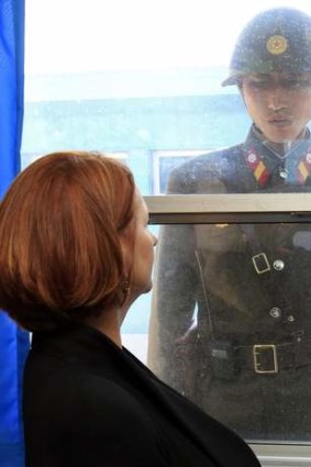 Australia's Prime Minister Julia Gillard and a North Korean soldier look at each other at the U.N. Command Military Armistice Commission meeting room in the demilitarized zone separating the two Koreas in April 24, 2011.