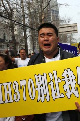 Grief and anger: A family member of the 153 Chinese victims joins protest accusing the Malaysian government of lying.