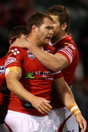 Points to prove: Dragons' Trent Merrin is congratulated after scoring a try against Storm last week.