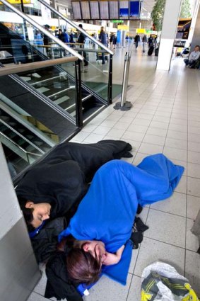 Passengers sleep at Schiphol Airport near Amsterdam.