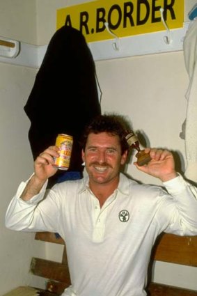 Allan Border holds up the Ashes in the dressing room after Australia regained the urn in 1989.