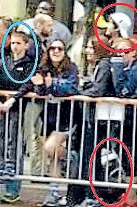 Suspect 2 walks within metres of who's thought to be eight-year-old Martin Richard, left.