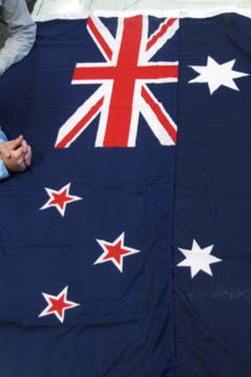 The flags of New Zealand (left) and Australia.