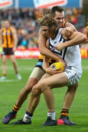Beleaguered ... Nathan Fyfe is tackled by Luke Hodge.