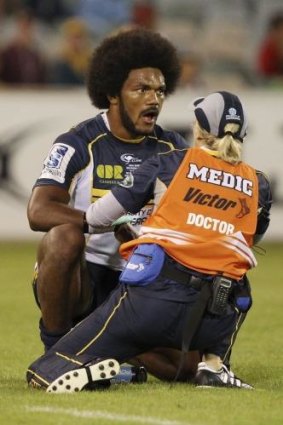 Brumbies winger Henry Speight receives attention after hurting his jaw during the victory over the Waratahs.