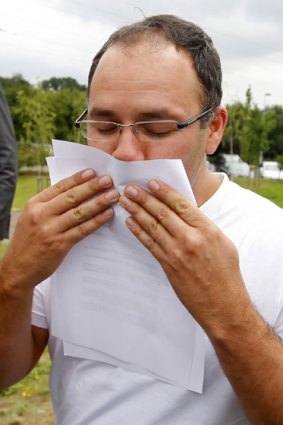 Michael Biggs, son of Ronnie Biggs, kisses his father's release papers outside Norwich Hospital.