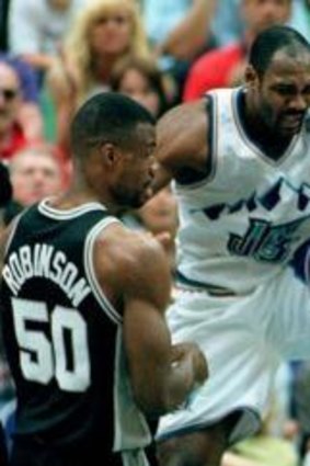 Tim Duncan cops a boot to the face during his rookie season in 1998 from Utah veteran Karl Malone as Spurs teammate David Robinson looks on.