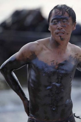 A local fisherman involved in oil spill cleanup work in Dalian.