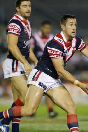 Mitchell Pearce from the Roosters looks to offload.