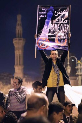 A protester in Cairo's Tahrir Square anticipates President Mubarak's resignation.