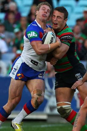 Hard knocks ... the Knights' Kyle O'Donnell, on debut, clashes with Rabbitoh Sam Burgess.