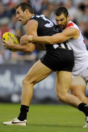 Caught: Travis Cloke is wrapped up by Sydney's Heath Grundy.
