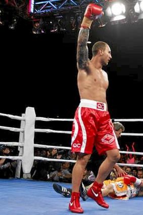 Quade Cooper punches the air after defeating Barry Dunnett by knock out.