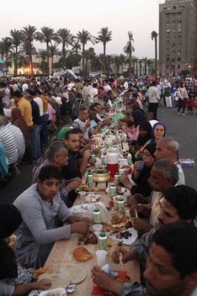 Families gather for a mass iftar (breaking fast) in Tahrir square, Waguih  earlier this month.