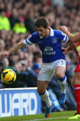 Leighton Baines competes with Liverpool's Jordan Henderson.