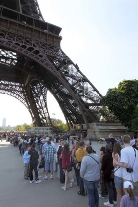 Queue horreur: Tourists line up to visit the Eiffel tower.