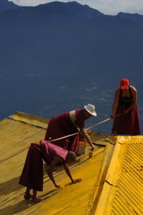 Buddhist monks paint the roof of the Tawang Monastery in Arunachal Pradesh.