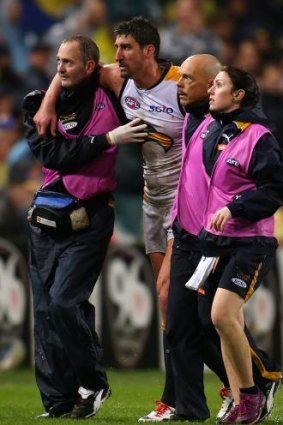 Dean Cox is assisted from the ground after being struck by Tyrone Vickery.
