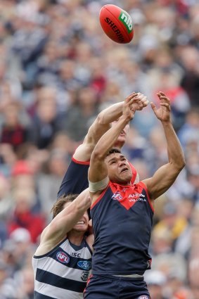 Melbourne's Neville Jetta flies for a mark with Patrick Dangerfield closing in.