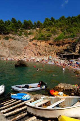 Sun-kissed ... sunbathers at a secluded cove at Cala Deia.