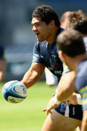 Rodney Blake offloads the ball during a Melbourne Rebels Super Rugby training session at Visy Park.