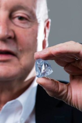Petra chief executive Johan Dippenaar holding the 122.52 carat blue diamond. 