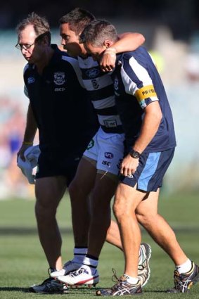 Geelong's Mathew Stokes is carried off with a leg injury during the game against West Coast on Saturday.