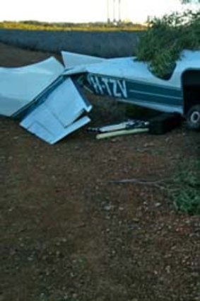 The wreckage of a Cessna, registered to Adrenalin Skydivers, that made a forced landing on a gravel road in 2010 in a photo from the  ATSB report.