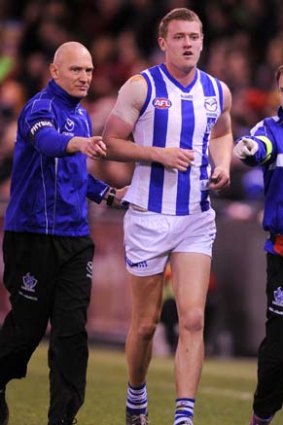 North Melbourne's Lachlan Hansen comes off after being injured at Etihad Stadium.