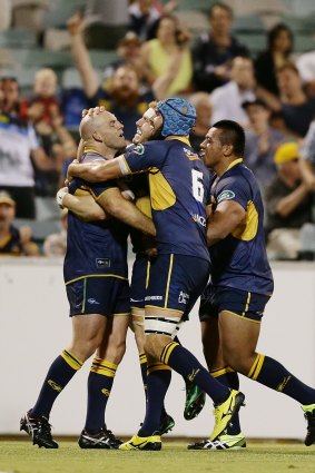 Stephen Moore of the Brumbies celebrates with teammates after David Pocock's try.