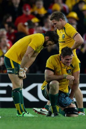The pain continues: After losing the Wallabies-Lions series, injury will keep James Horwill (kneeling) out of the Reds' team to face the Waratahs.