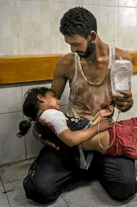 Mohammed Shinbary comforts injured daughter Mahasin, 7.