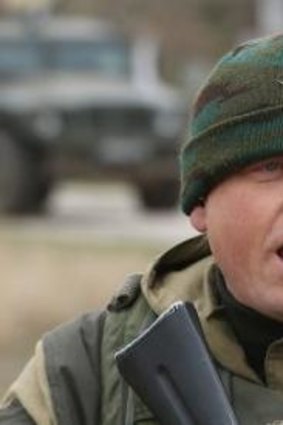 A soldier under Russian command warns unarmed Ukrainian troops that he will shoot