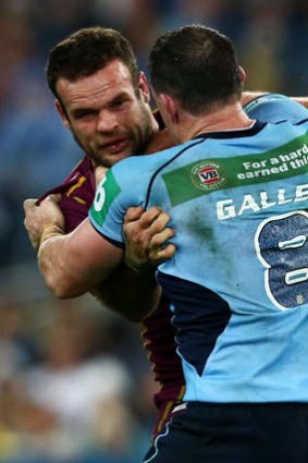 Paul Gallen of the Blues punches Nate Myles of the Maroons.
