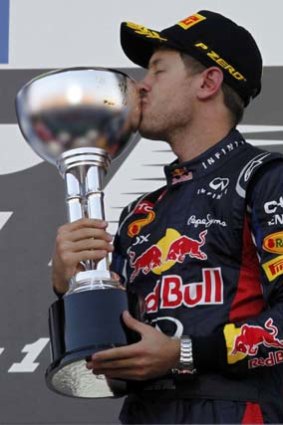 Sebastian Vettel kisses his trophy after winning the Japanese F1 Grand Prix.